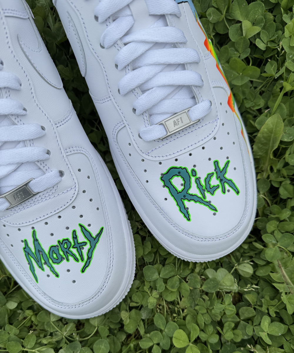 Modèle présenté : Nike Air Force 1 Custom Rick & Morty Arc-en-ciel, avec Rick peint sur une chaussure et Morty sur l’autre, sur les côtés externes. Un arc-en-ciel coloré traverse la paire de l’arrière vers l’avant, apportant une touche lumineuse et originale. Réalisée à la main avec des peintures professionnelles résistantes à l’eau, cette custom est parfaite pour les fans et les amateurs de sneakers uniques.